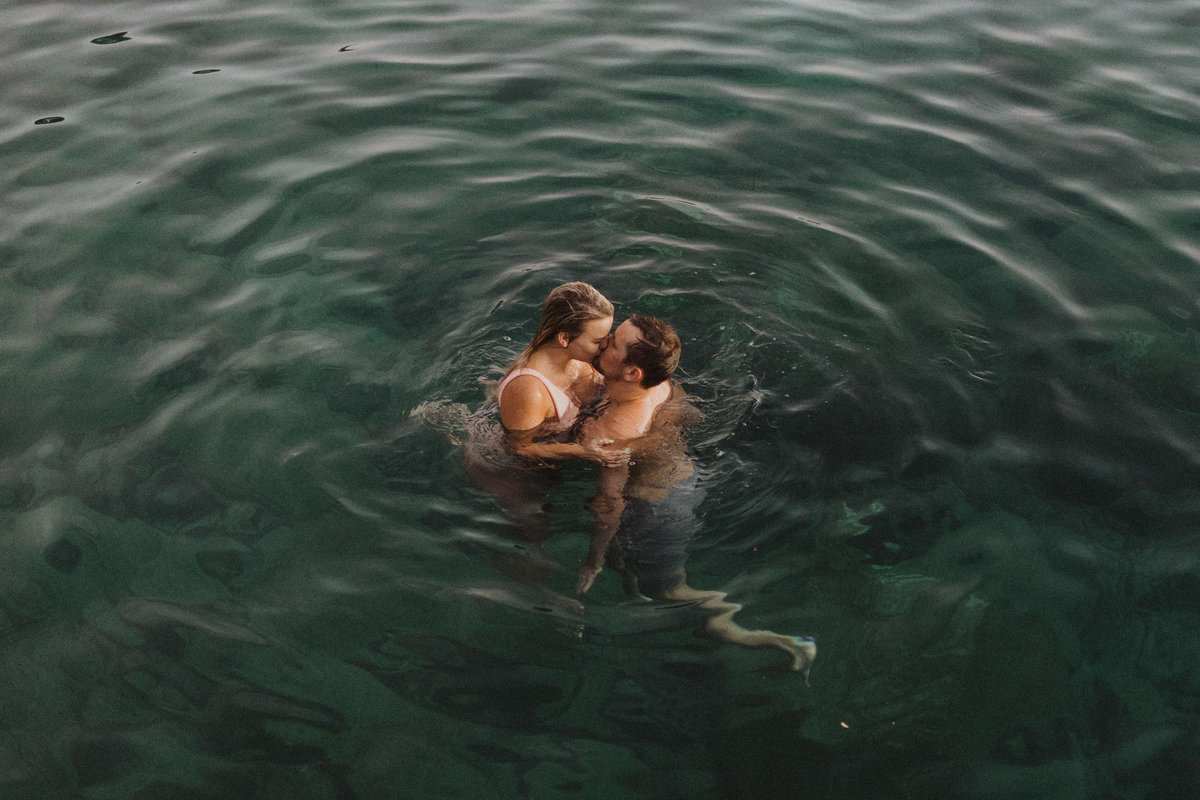 couple kissing & swimming in  water