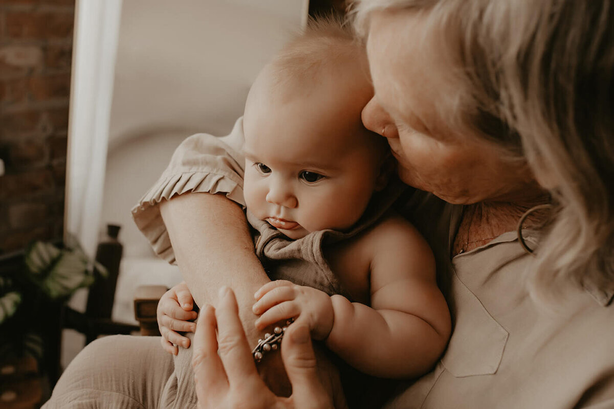a grandma kissing her grandson