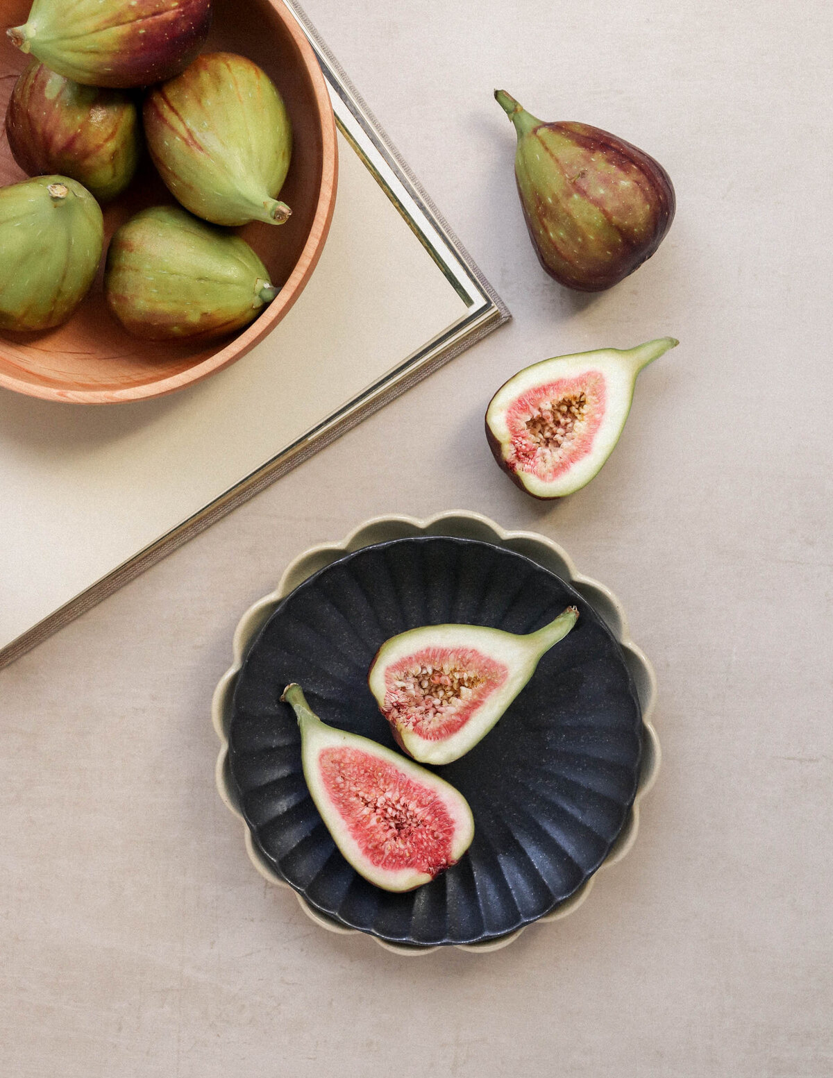 Figs cut in halves in a ornate black bowl