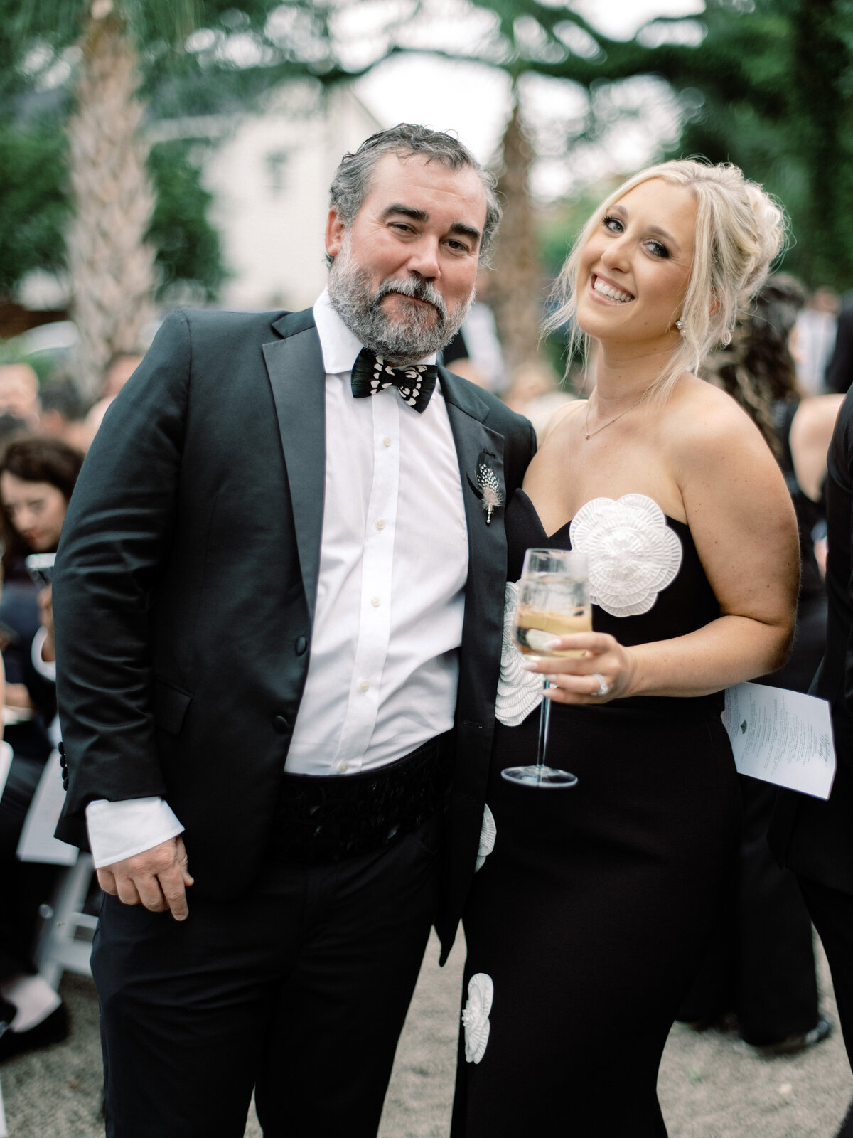 A charming couple dressed elegantly, enjoying a moment at a stylish event, encapsulating the joy and sophistication of weddings. 