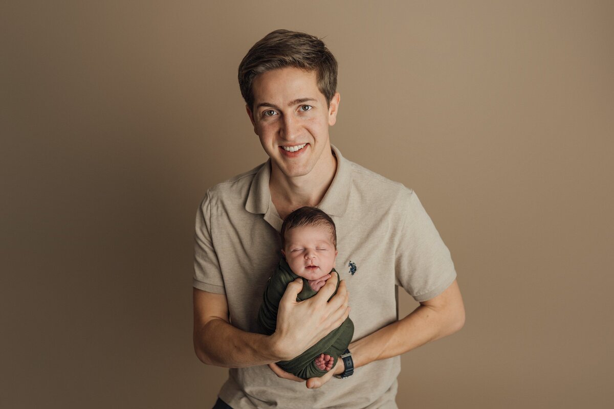 dad and newborn boy in tampa photography studio
