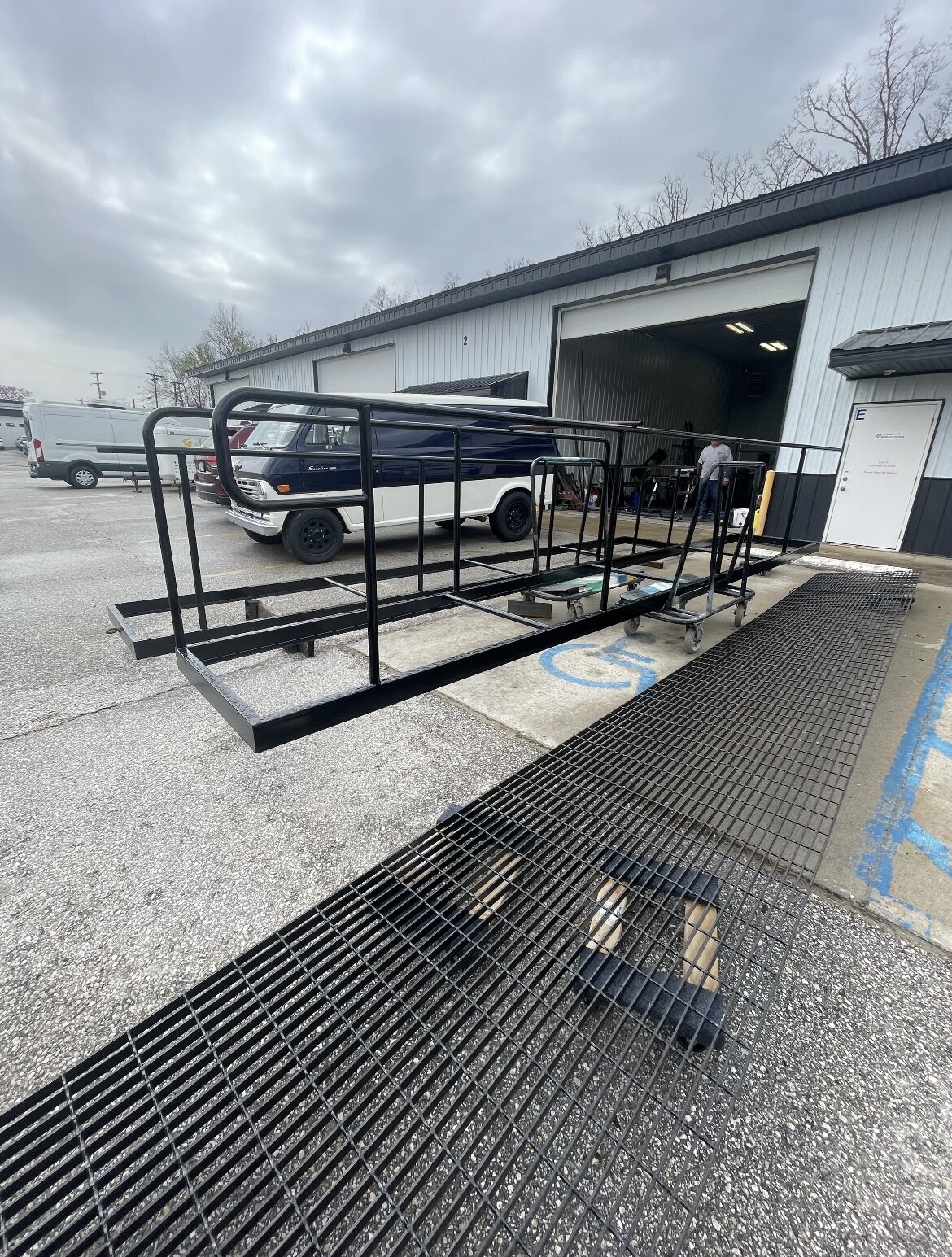 Partially completed welded steel frame being fabricated for a new shop structure during early construction phase.