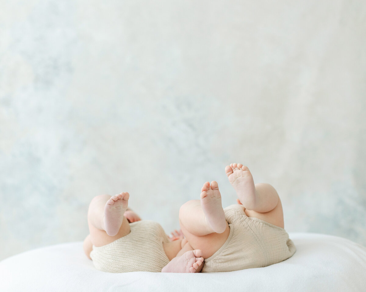 Two babies kick their feet