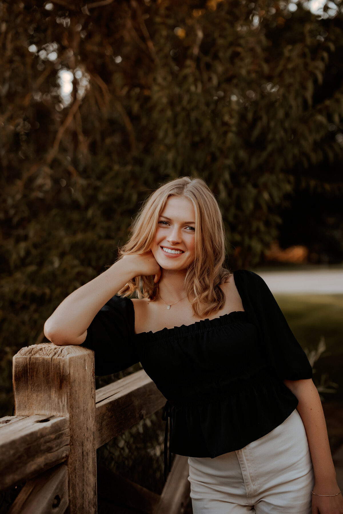 HIgh school senior girl wearing a black shirt on a fall day at a park in Westminster Colorado 