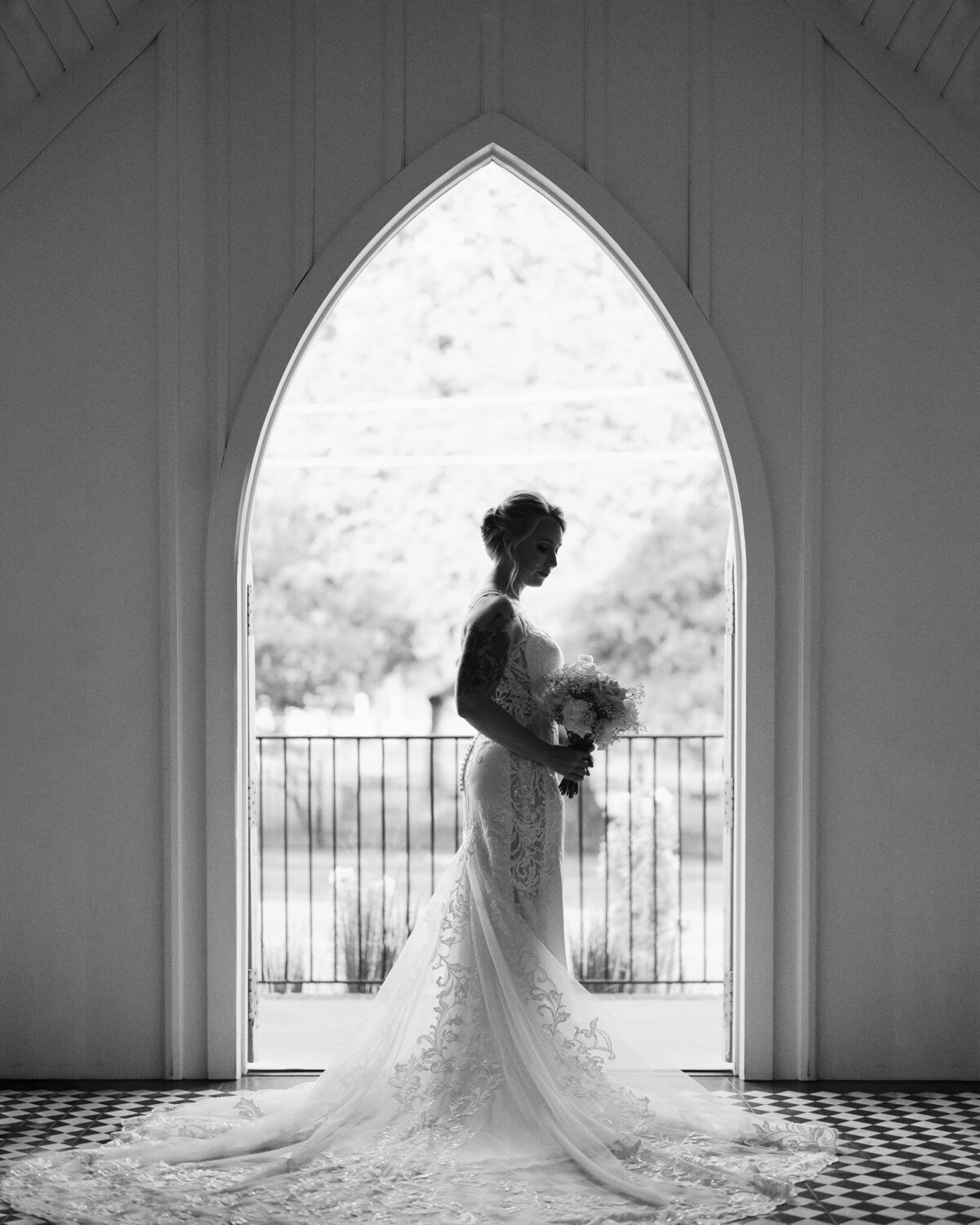 An editorial-style silhouette bridal portrait taken at All Saints Chapel in downtown Raleigh, captured by North Carolina wedding photographer Jessica Leigh Mason.