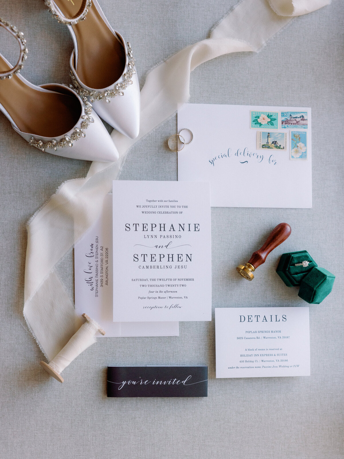 A top down view of the wedding details including the wedding invitation, the wedding rings, and the bride's shoes