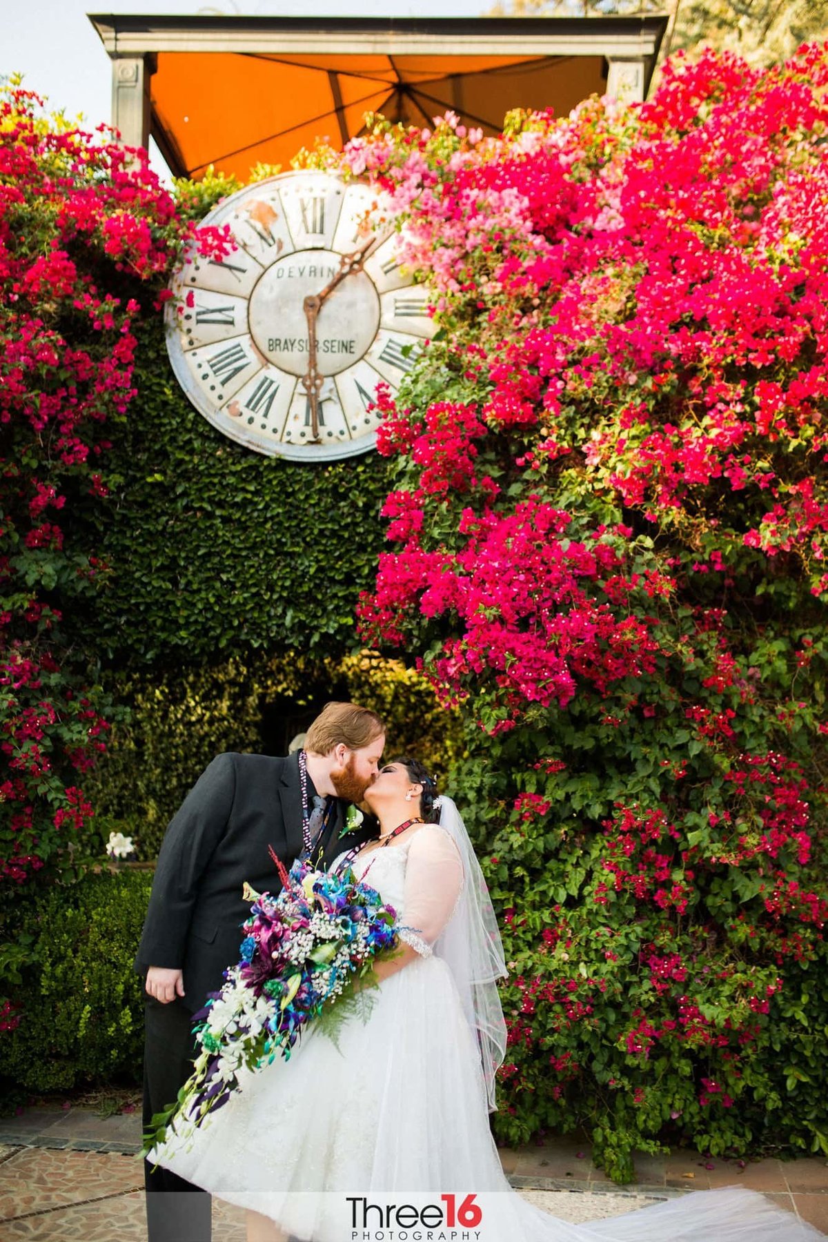 Groom steals a kiss from his Bride