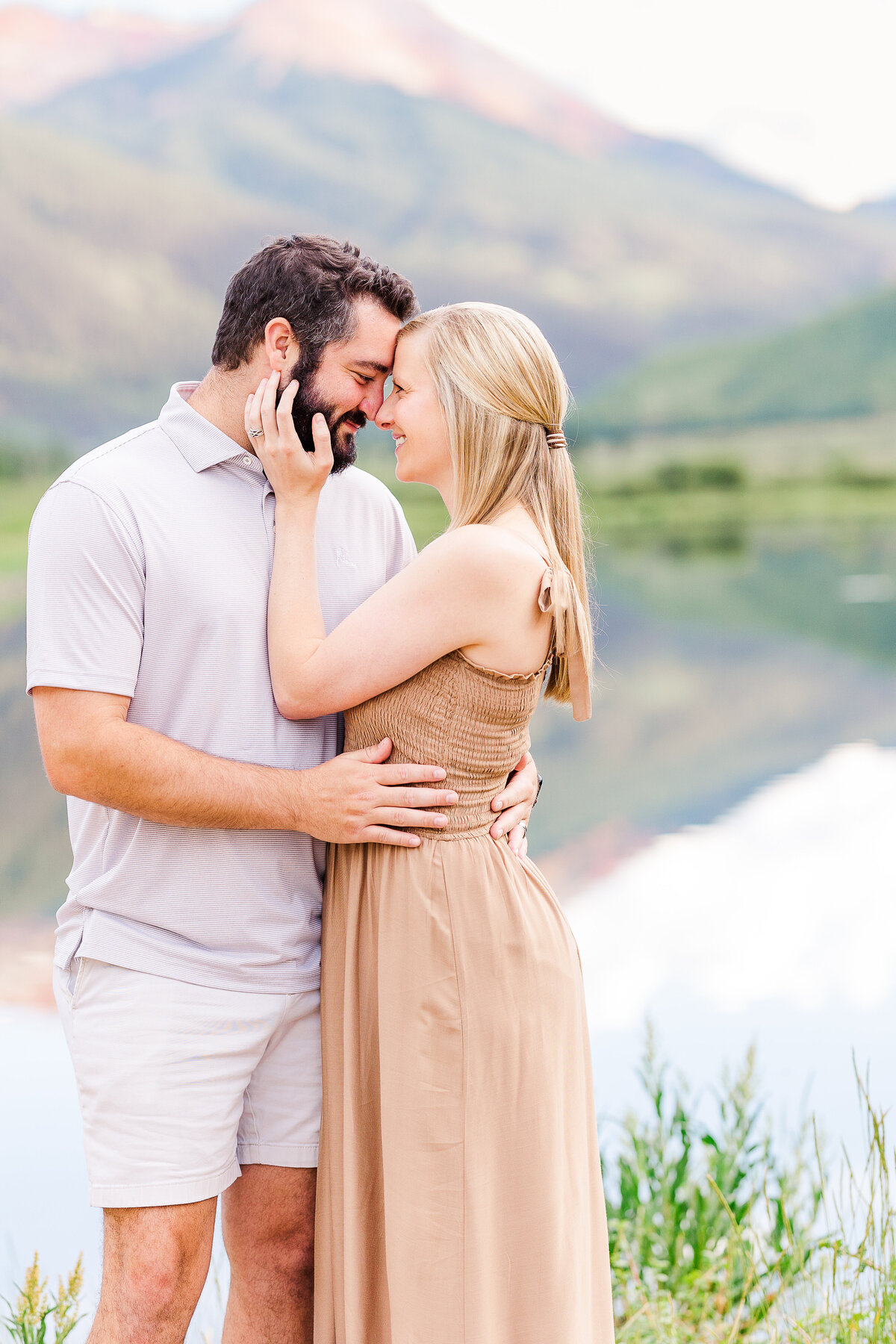 Couple sharing a tender moment at Crystal Lake on Red Mountain Pass in Ouray, CO during a family session