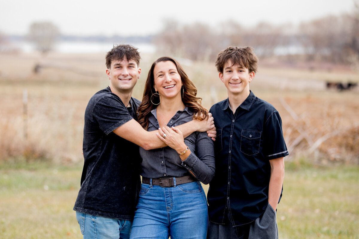 two teen sons pose by their mom