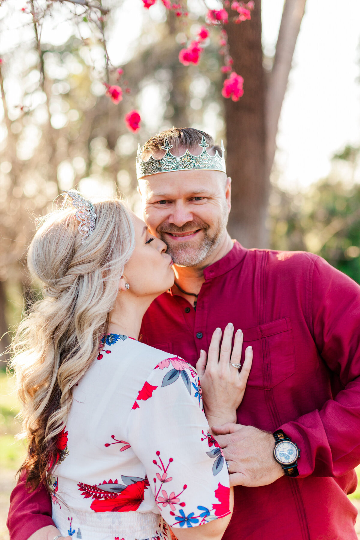 engaged couple waring crowns with cherry blossoms