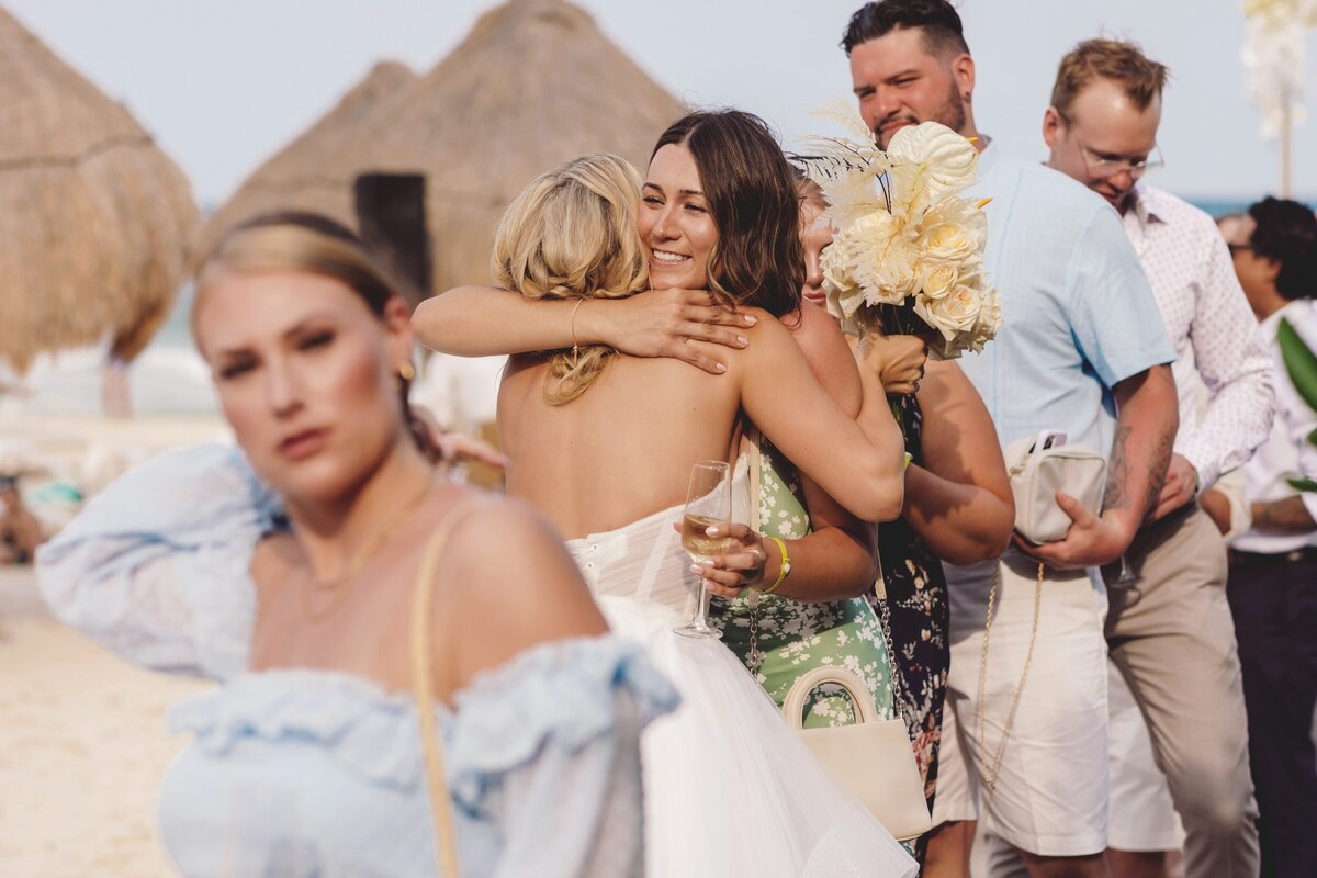 Bride hugging guests at wedding in Riviera Maya