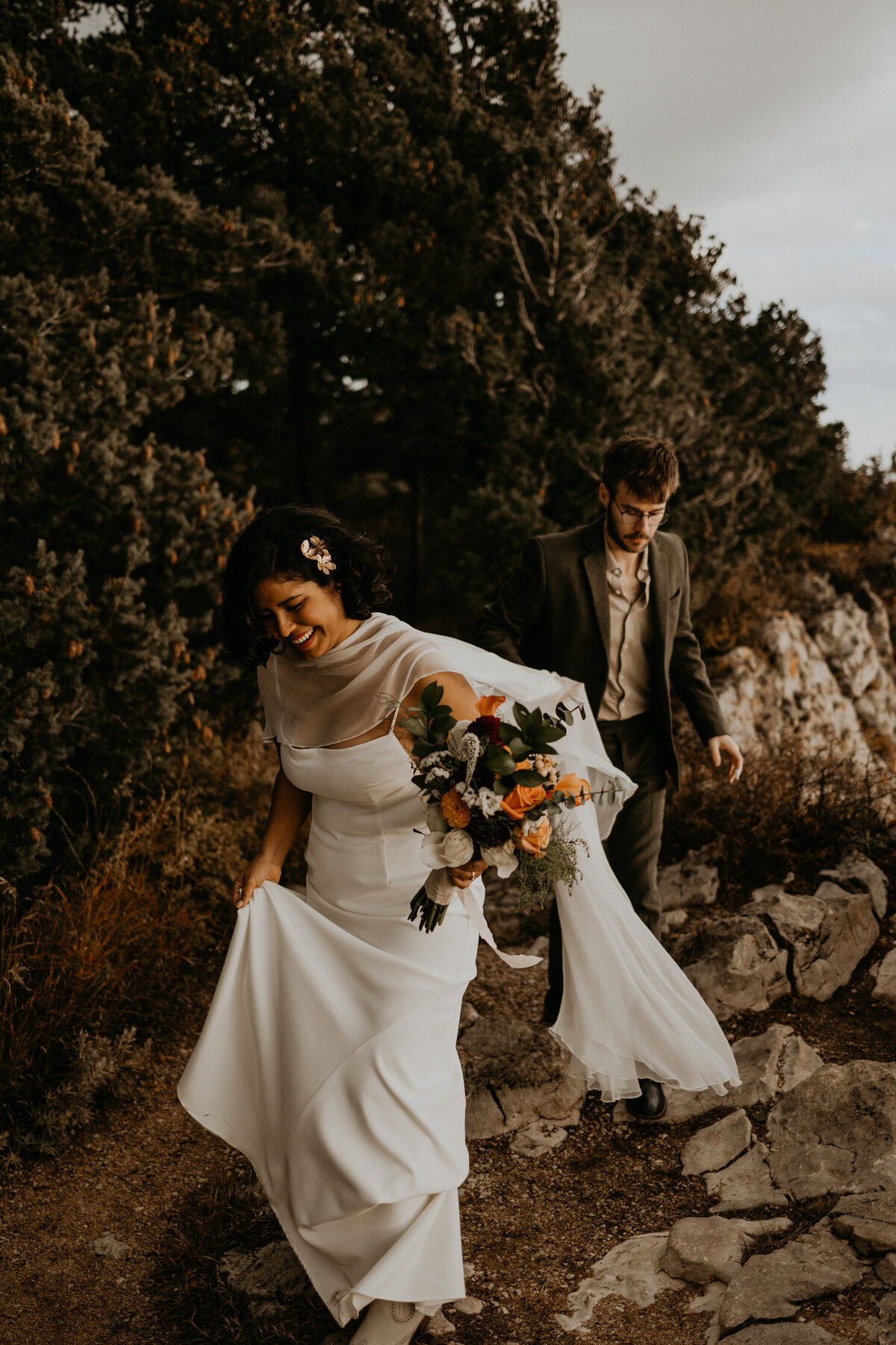 newlyweds walking along the Sandia Mountain Peak