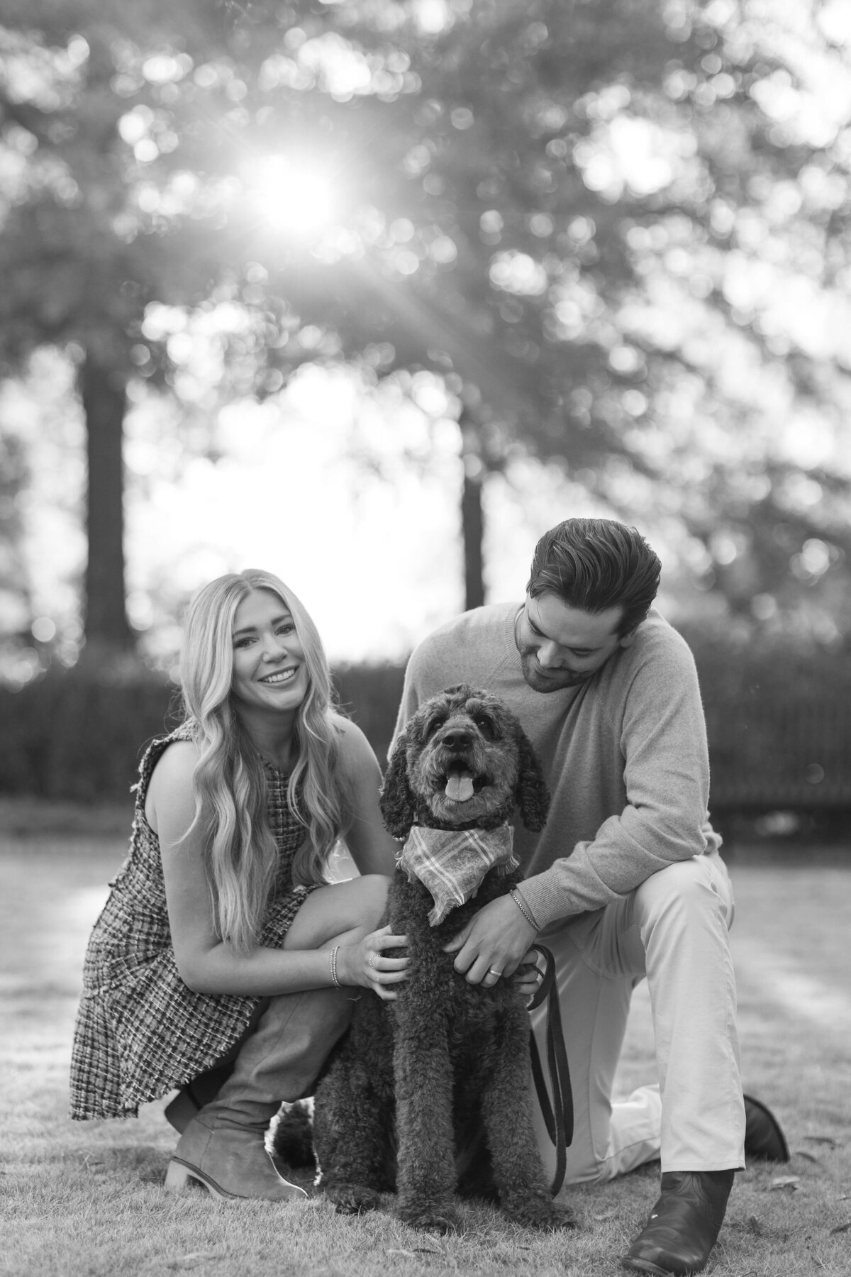 Woman and man smiling with their dog