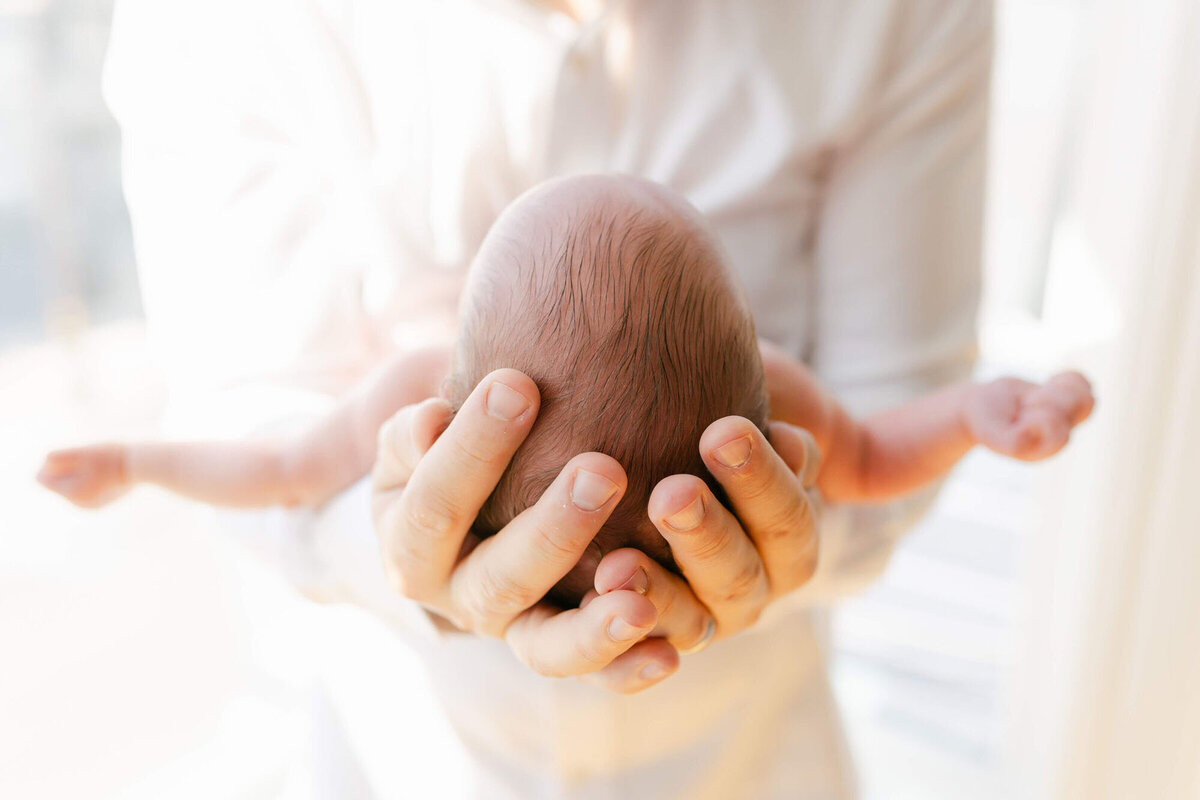 Parents cuddling their newborn during an in-home San Francisco Bay Area newborn photographer session.