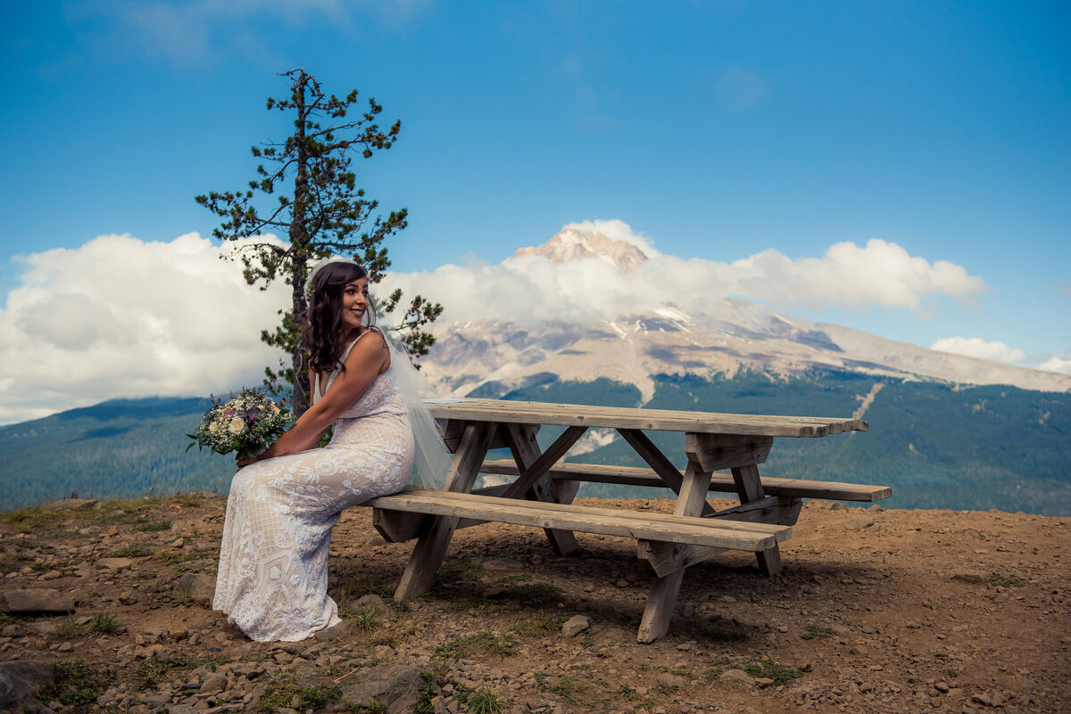bride sitting on picnic table