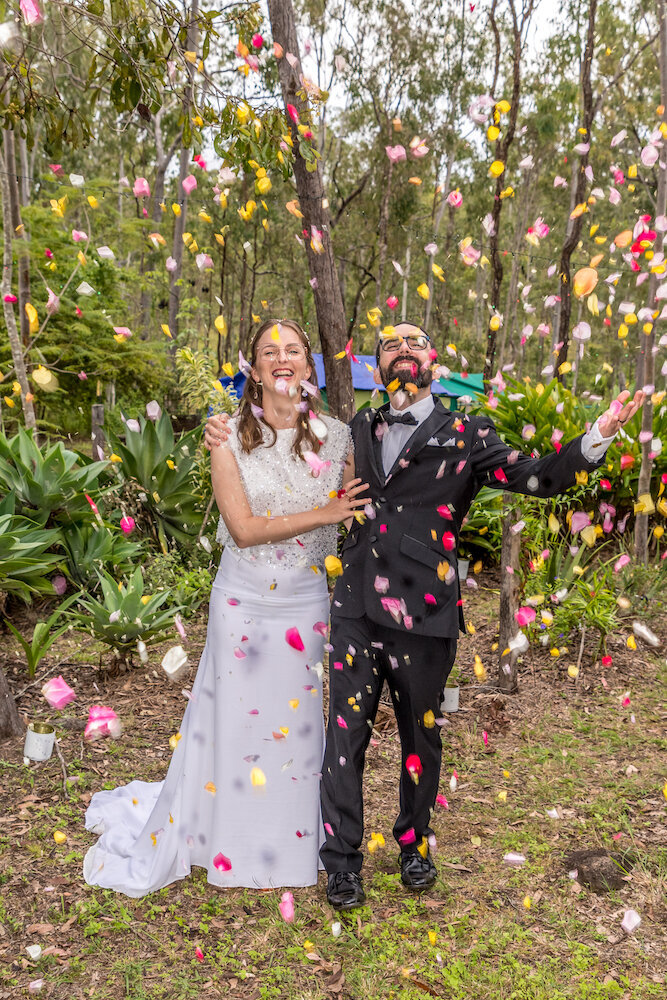 atherton bride and groom basking in confetti - Townsville Wedding Photography by Jamie Simmons