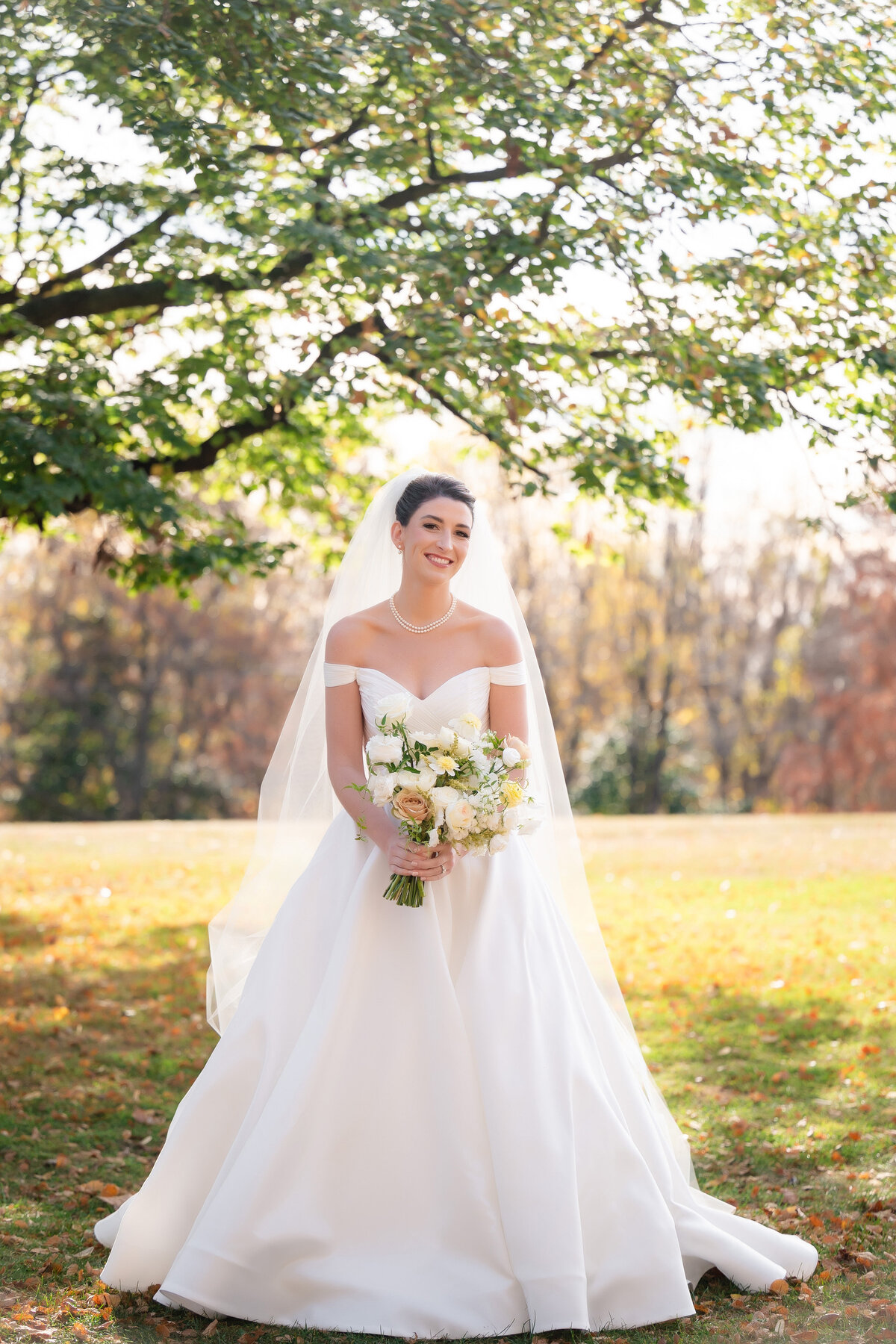 wedding photo of a bride in the autumn sunlight at schenley park pittsburgh