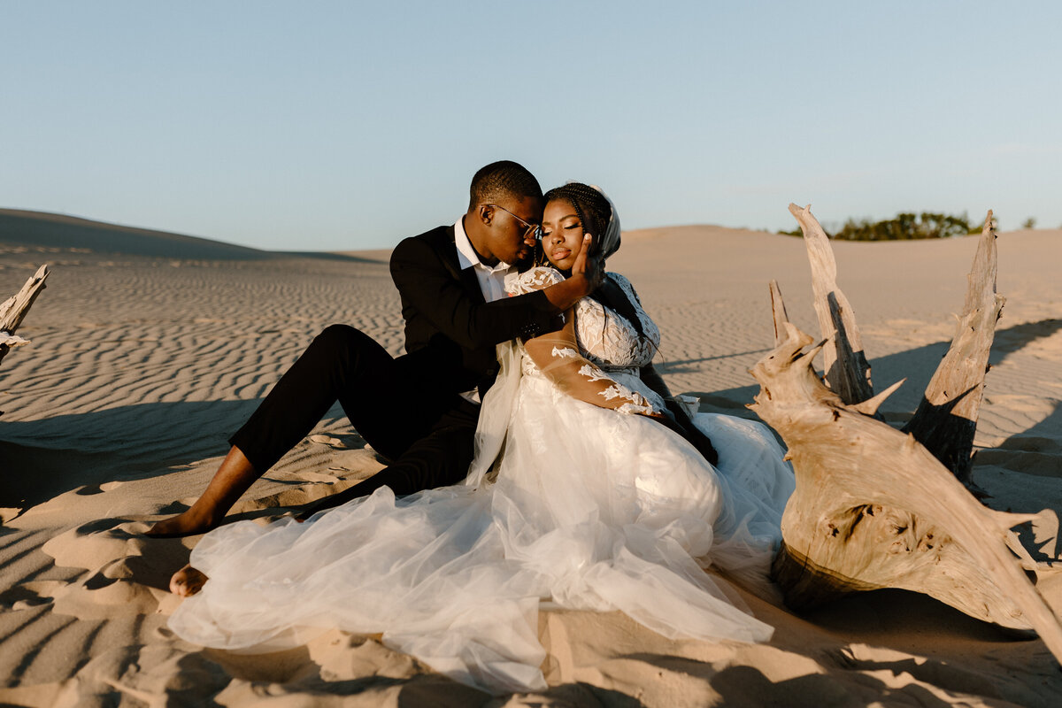 wedding couple in sand dunes at sunset