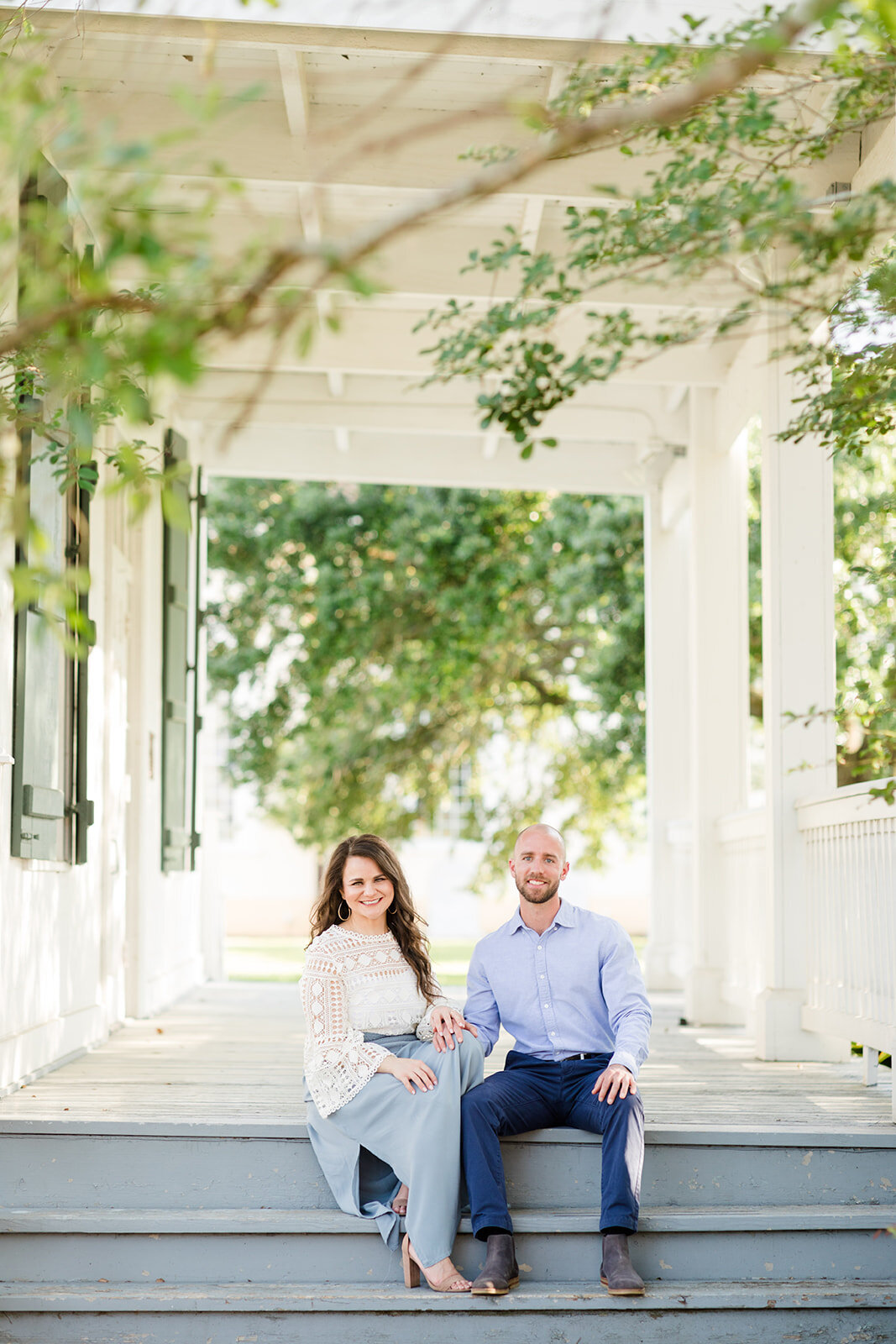 Engagement photo of couple sitting on porch in St. Martinville, Louisiana