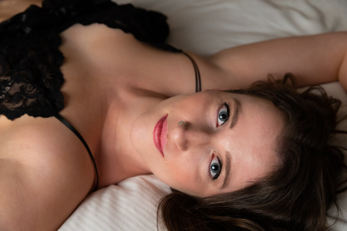 Boudoir photograph of Missoula woman in black lingerie laying on bed