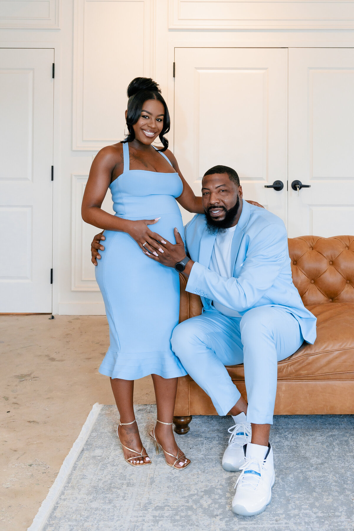 Couple poses for their baby shower at Upstairs Atlanta.
