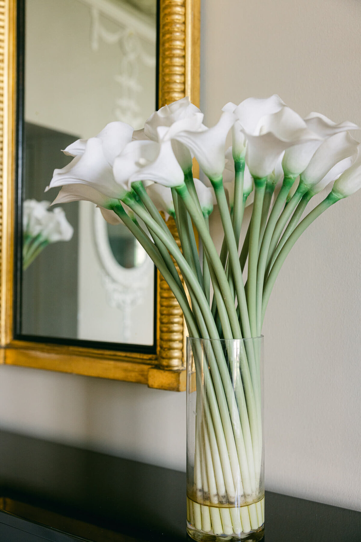 A wedding photo of white lilly flowers in a vase at Luttrellstown Castle in Ireland