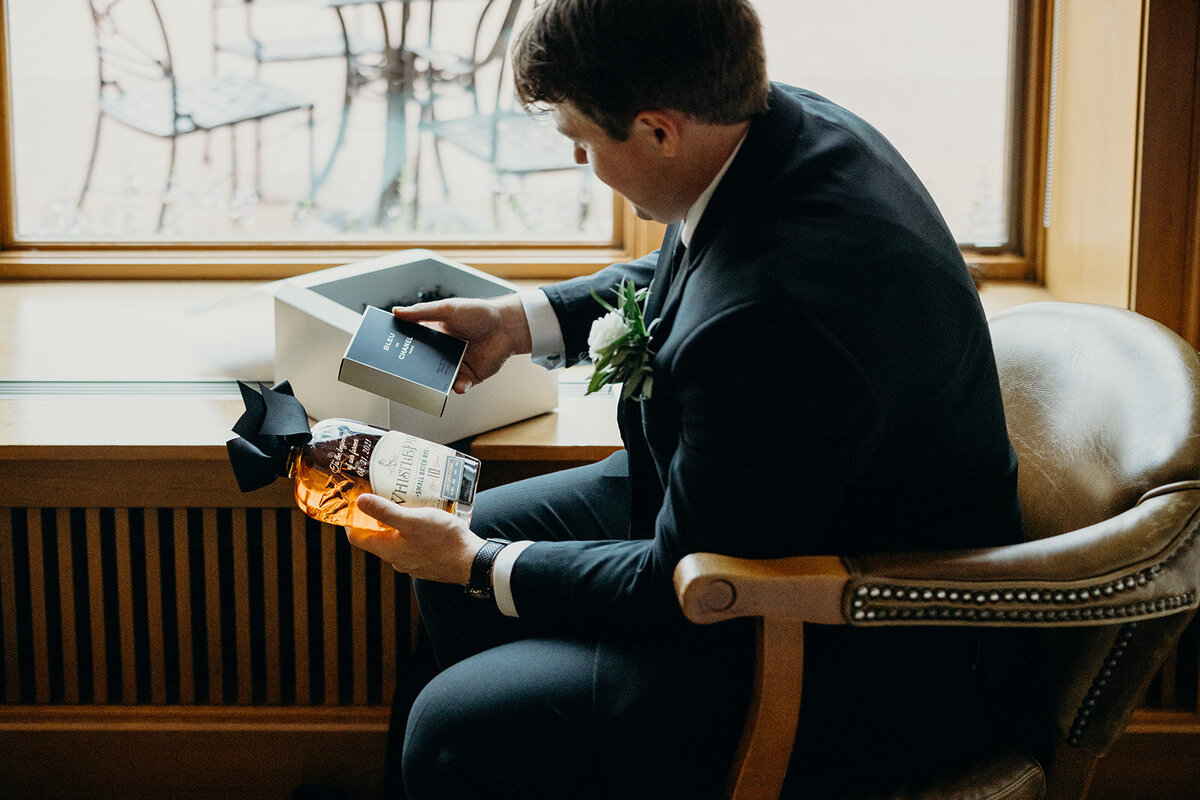 Groom opening gift from bride