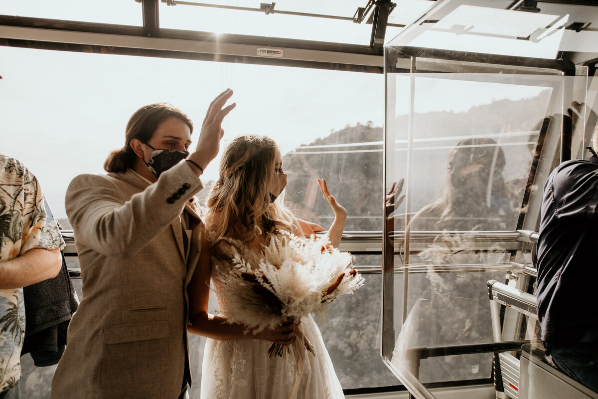 bride and groom riding the sandia peak tram together for their elopement