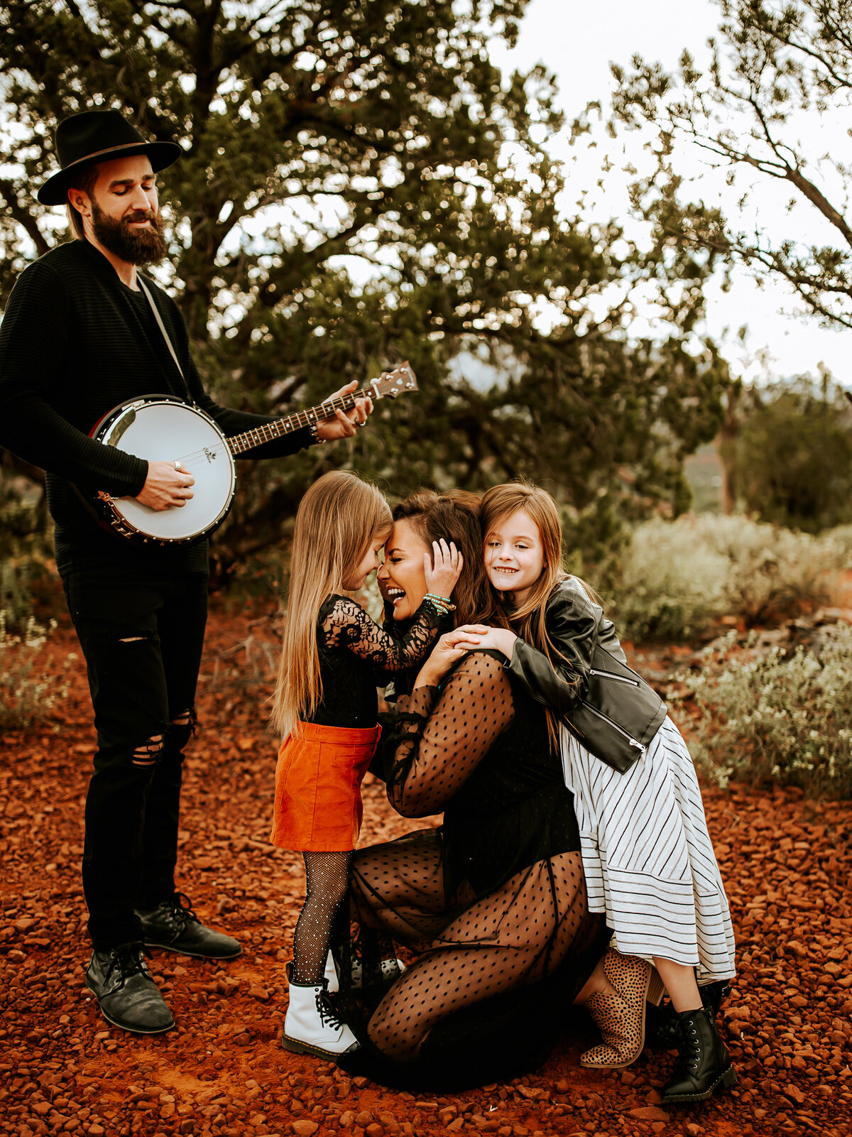 dad playing banjo with mom and girls