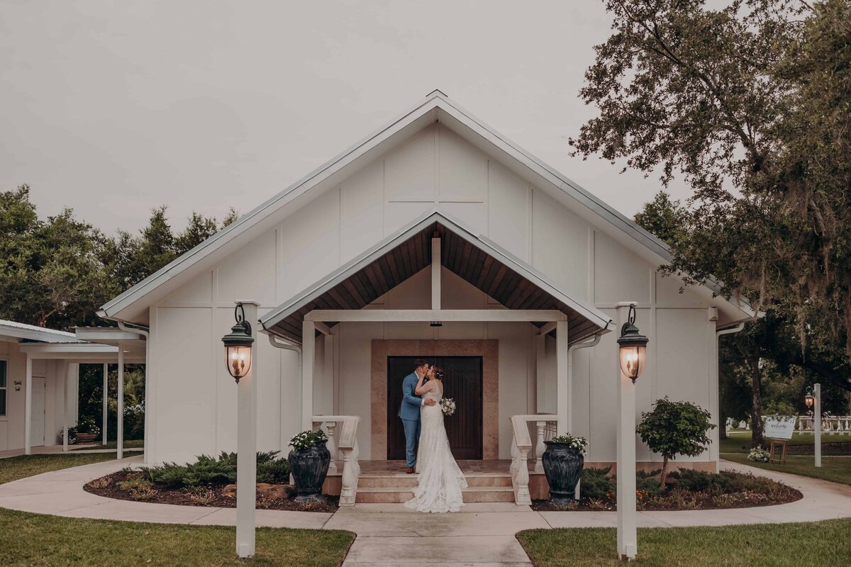 Bride groom pose for portraits at The Manor, a Diamond C Ranch barn wedding, in Sarasota Florida.