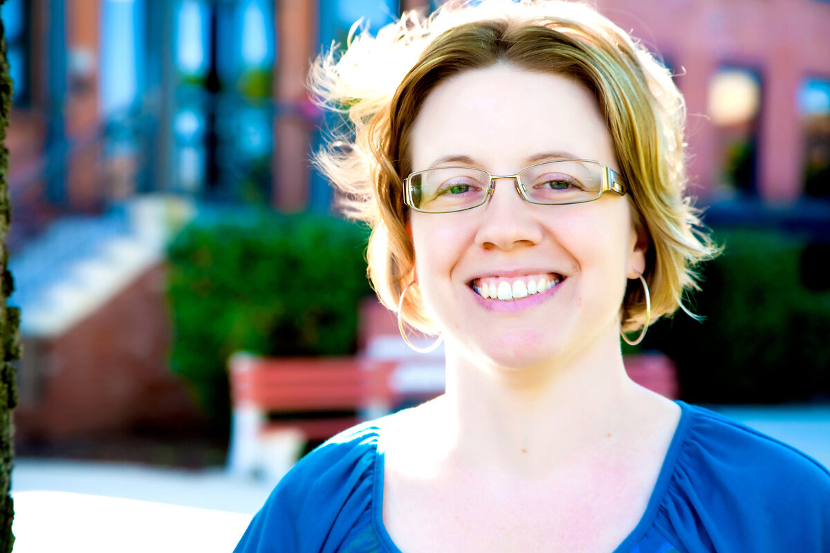 A female client's headshot that is outdoors