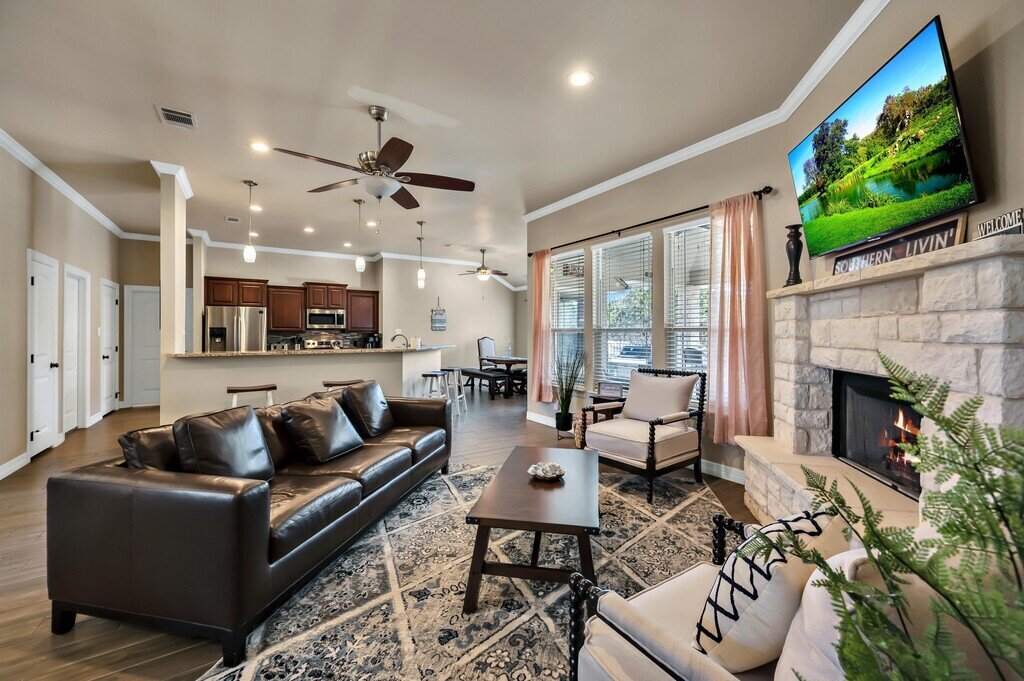Living room and open concept kitchen in this three-bedroom, two-bathroom vacation rental lake house that sleeps eight just steps away from Stillhouse Hollow Lake in Belton, TX.