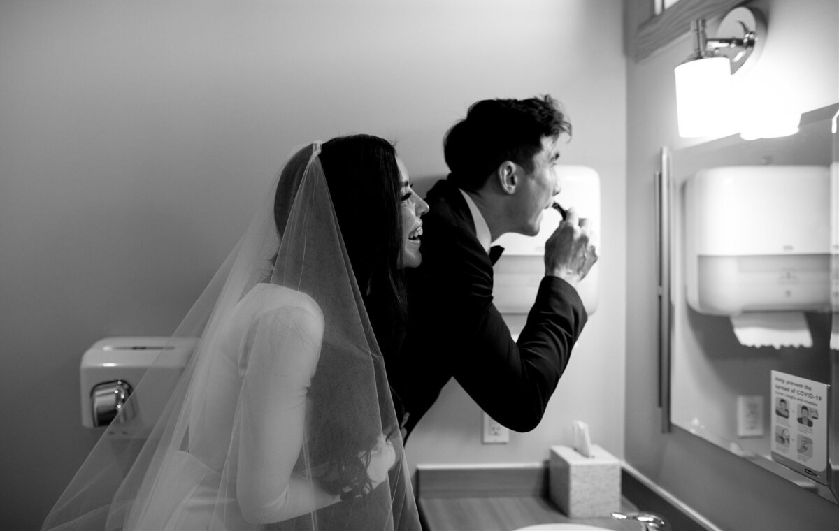 bride and groom looking in a mirror
