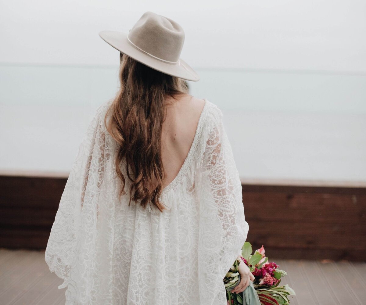 Bride Standing On Boardwalk Against Sky