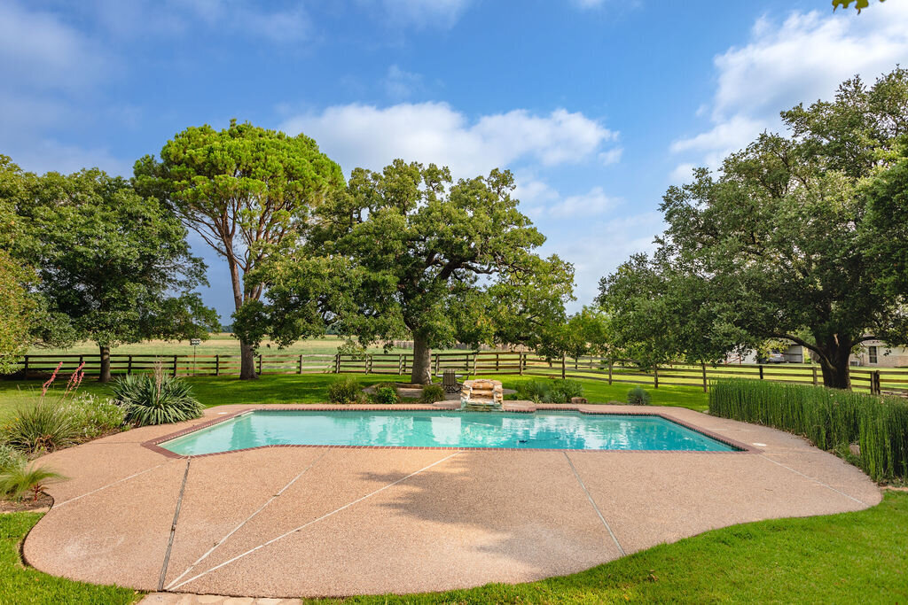 Outdoor swimming pool at this 5-bedroom, 4-bathroom vacation rental house for 16+ guests with pool, free wifi, guesthouse and game room just 20 minutes away from downtown Waco, TX.