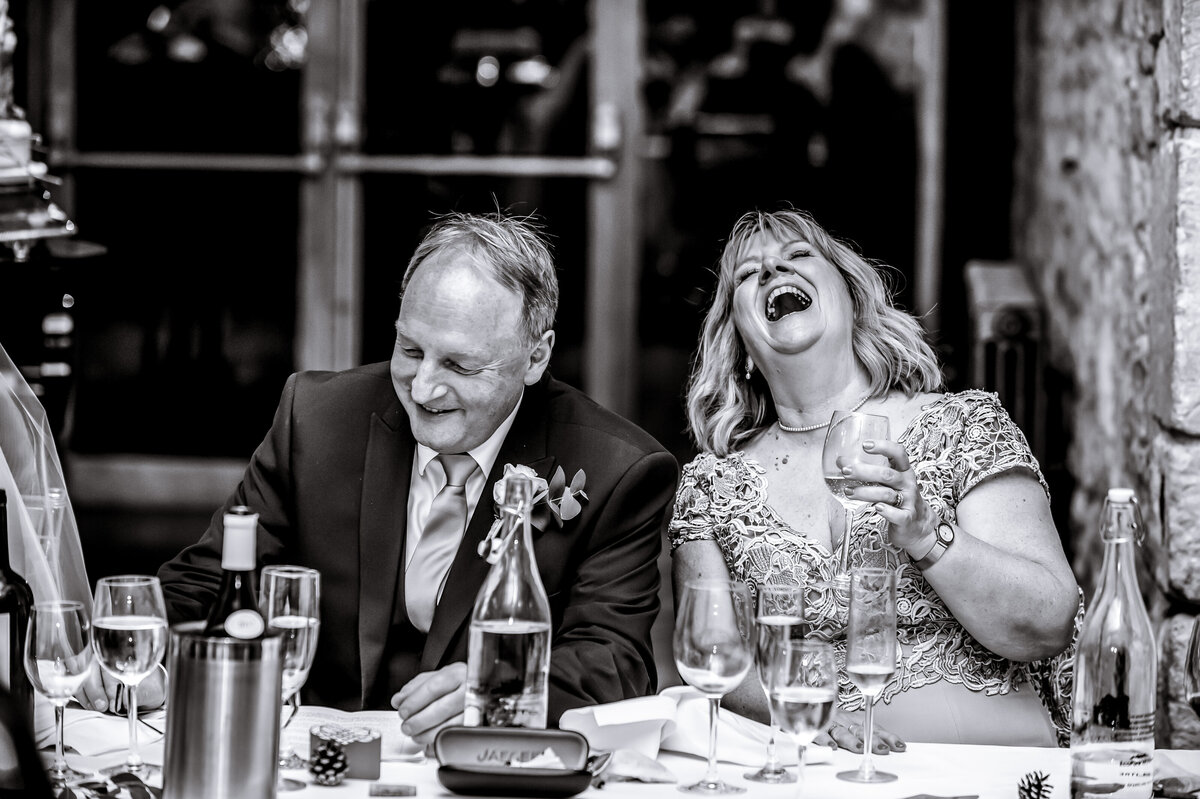 couple during reception laughing