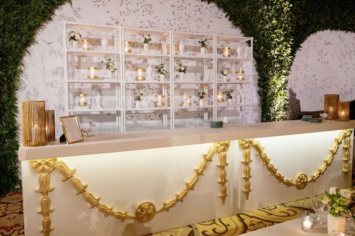 Delicate floral arrangements and candles displayed on a white shelving unit, enhancing the romantic decor.