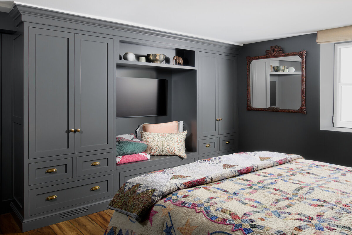 bedroom with gray built-in cabinets with patterned duvet cover