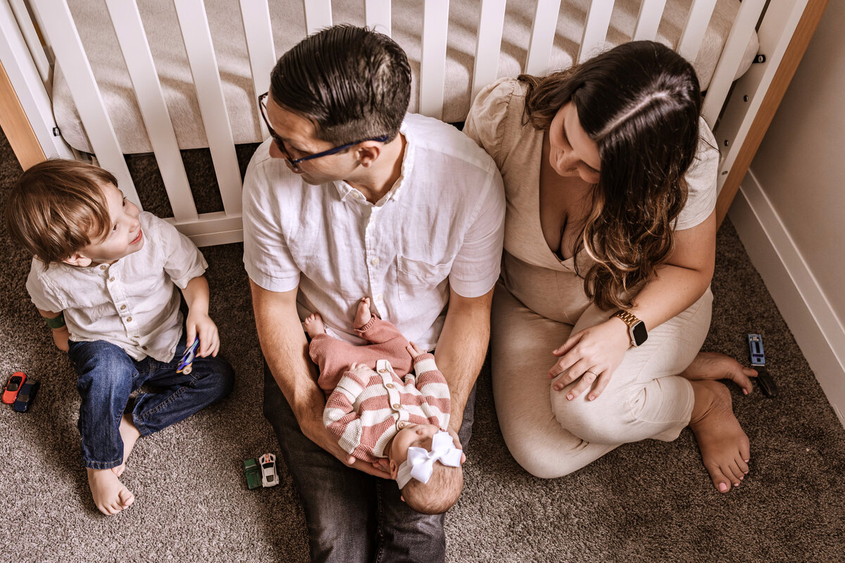 family with baby in nursery
