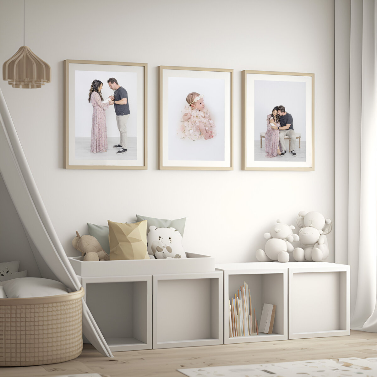 A modern newborn nursery with three handing family portraits of newborn baby and whole family.