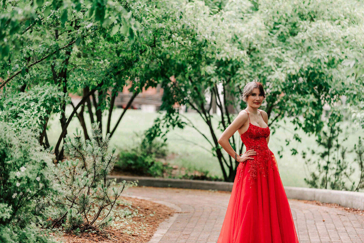 Standing on a path with trees over head. 