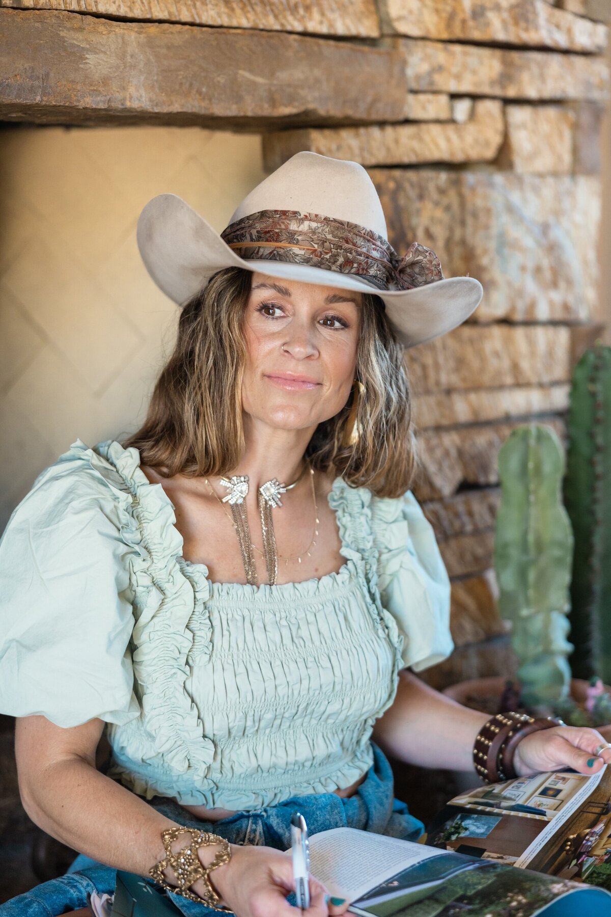 a woman in a cow girl hat