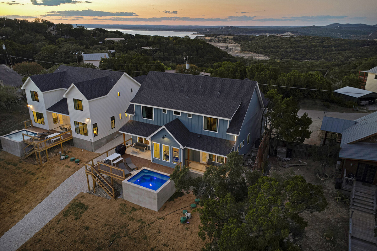 backyard aerial view of home with small square concrete pool and elevated wood deck