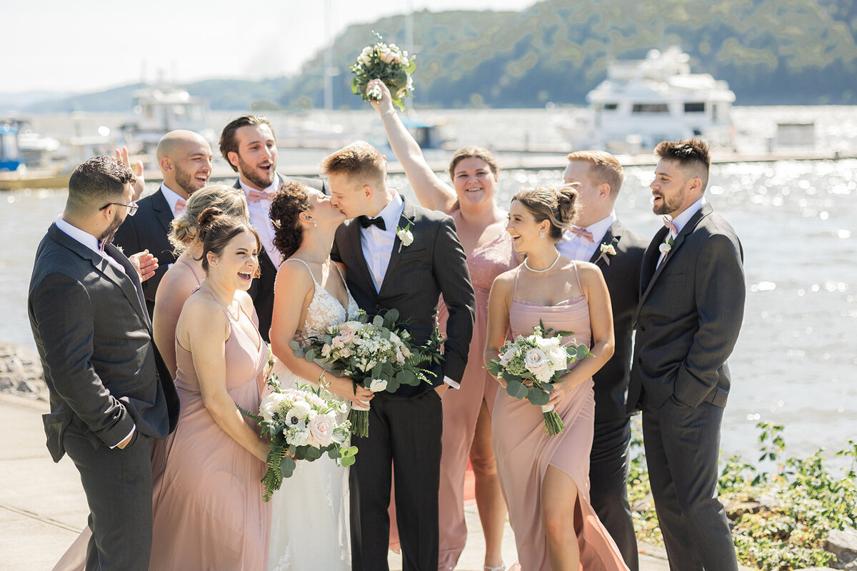 bridal party cheer on couiple as they kiss