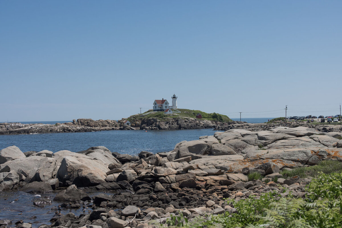 Rocky coastline with a lighthouse in the distance