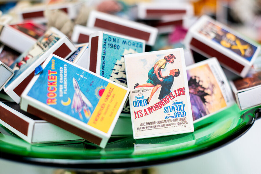Bowl of matchbooks with retro artwork on boxes.