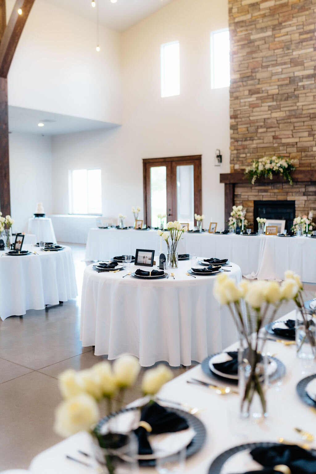 Reception tables set beside the stone fireplace