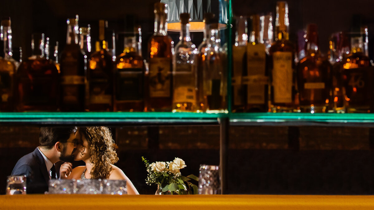 Romantic bride and groom kissing at the bar at The Preston at the Chase Park Plaza Hotel in St. Louis