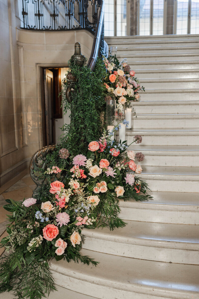 cascading greenery and flowers along grand staircase wedding