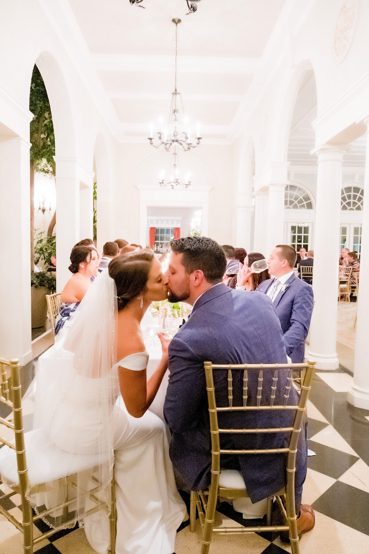 couple kissing at dinner table at fox chapel golf club